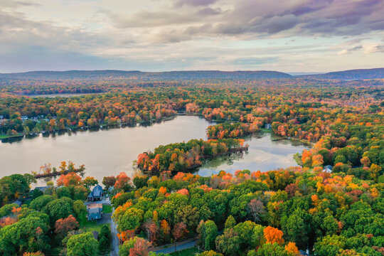 Kemah Lake in Hampton Township, Sussex County, NJ, surrounded by brilliant fall foliage at dusk aerial drone