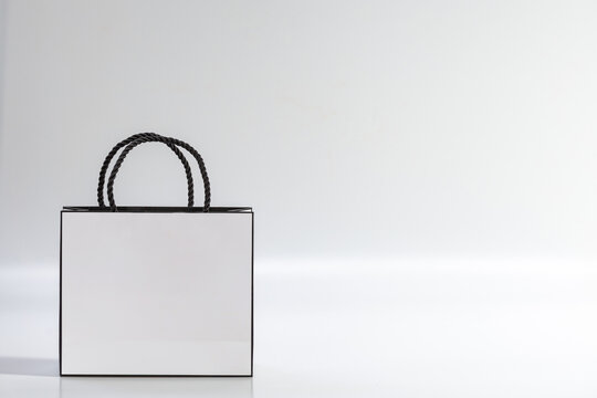 Empty white shopping bag on blue background, top view