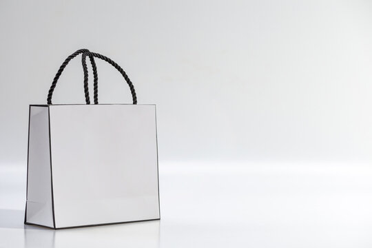 Empty white shopping bag on blue background, top view