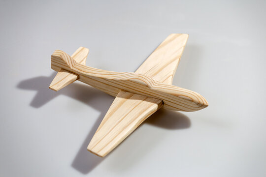 Wood airplane on white background, top view