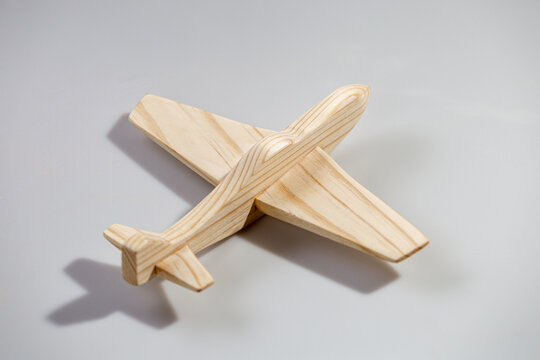 Wood airplane on white background, top view