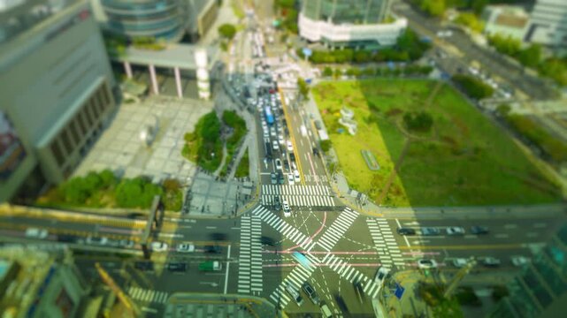 High-angle time-lapse of city traffic with a tilt-shift effect, creating a miniature toy-town look in downtown Seoul.
