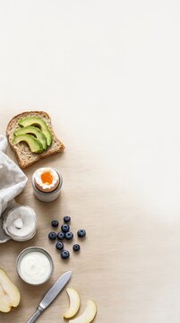 Minimal Nordic Breakfast Flat Lay With Avocado Toast, Egg, Yogurt, Berries, And Pear On Wood Table.