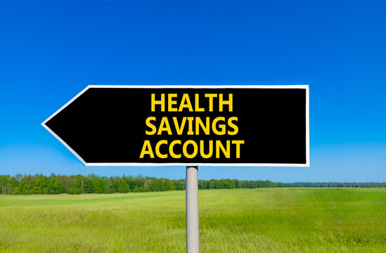 Health saving account symbol. Concept words Health saving account on beautiful black road sign. Beautiful blue sky green grass background. Medical Health saving account concept. Copy space.