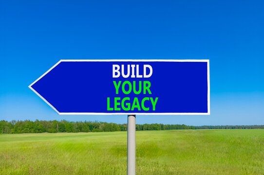 Build your legacy words symbol. Concept words Build your legacy on beautiful blue road sign. Beautiful blue sky green grass background. Business build your legacy concept. Copy space.