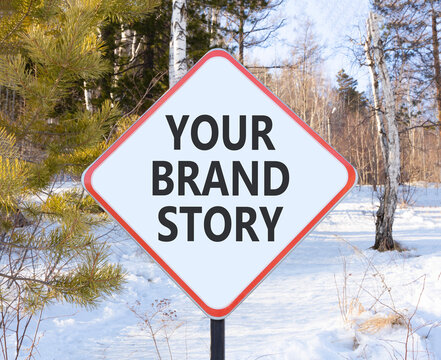 Branding and your brand story symbol. Concept words Your brand story on beautiful white road sign. Beautiful winter forest background. Business branding your brand story concept. Copy space.