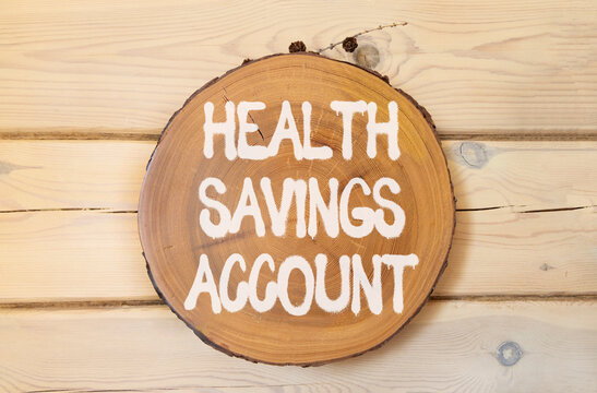Health saving account symbol. Concept words Health saving account on beautiful wooden circle. Beautiful wooden wall background. Medical Health saving account concept. Copy space.