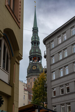 The distinctive green copper spire and clock tower of St. Peter's Church in Riga Latvia