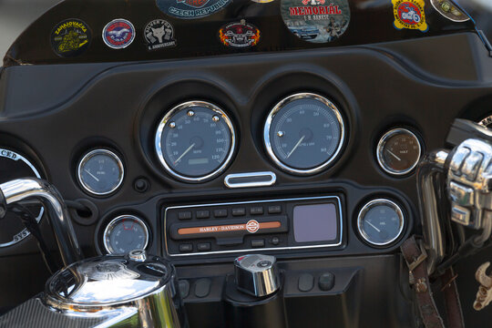 Close-up of motorcycle instrument panel showing speedometer, tachometer, fuel gauge, oil and volt meters with chrome trim and control buttons.