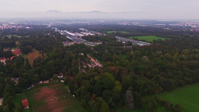 Aerial drone view of Autodromo Nazionale Monza in Monza, Italy, showcasing the iconic Formula 1 racing circuit, racetrack, grandstands, and surrounding parkland.