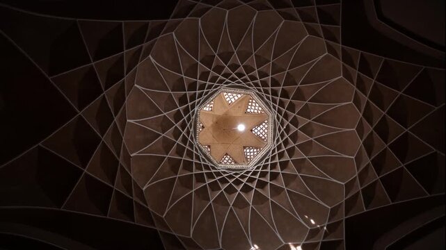 Cinematic low angle view of Dowlatabad Garden windcatcher dome ceiling, intricate Persian geometric architecture pattern, historic design in Yazd, Iran..