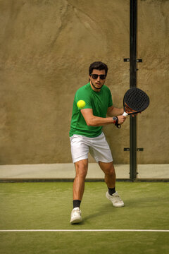 Padel player with racket on court in action at tournament