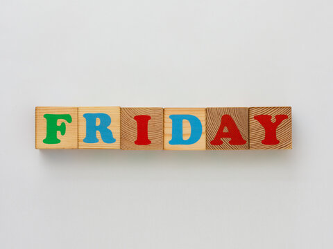 Wooden blocks with colorful letters spelling out the word FRIDAY