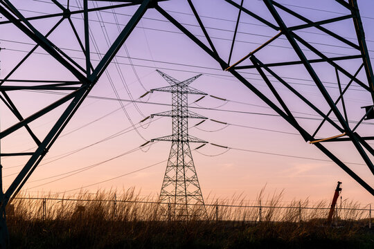 Power grid infrastructure with overhead transmission lines.