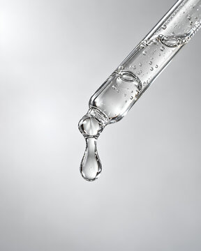 Clear Skincare Serum Dropper with Liquid Droplet and Copy Space, water drop on a glass