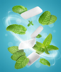 Menthol chewing gum pieces and mint leaves in air against blue background © New Africa
