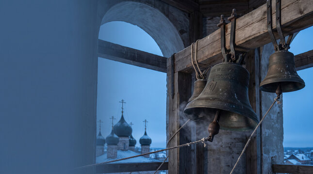 Church bells ringing at dusk with towers in the background  