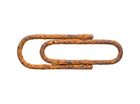Rusted paperclip isolated on black background, capturing bureaucratic decay and professional obsolescence with weathered metal texture for conceptual business and editorial design.