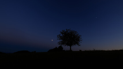 Moon on a twilight sky with stars, planets and landscape mountain silhouettes. © astrosystem