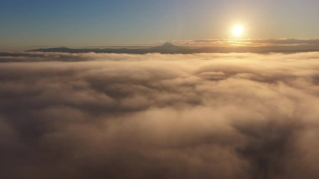 Sunrise illuminates low clouds drifting through the Willamette Valley, just south of Portland, Oregon. This scenic Pacific Northwest region is less than an hour drive from Mt. Hood.