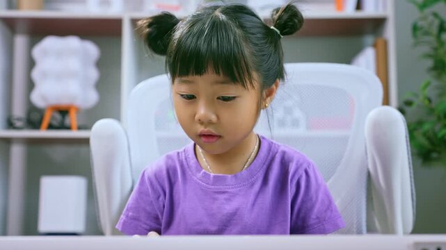 Asian girl practicing piano keyboard at home while smiling and learning musical instrument