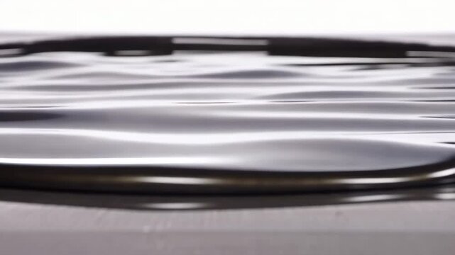 Dark graphite titanium liquid forming gentle horizontal ripple in