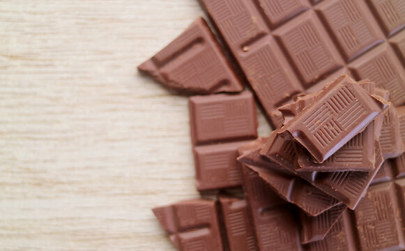 Top View of chocolate chunks pile on wooden background with copy space