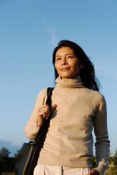 Woman Enjoying a Sunny Day Outdoors With a Peaceful Expression
