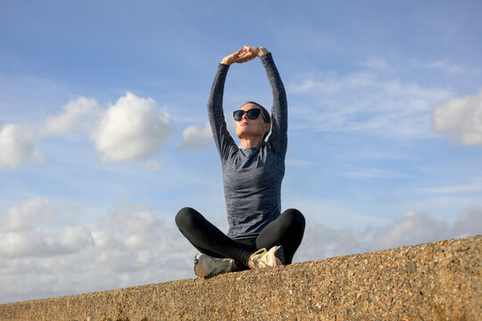 Woman Practicing Yoga and Stretching, Outdoors Warm Up Exercise