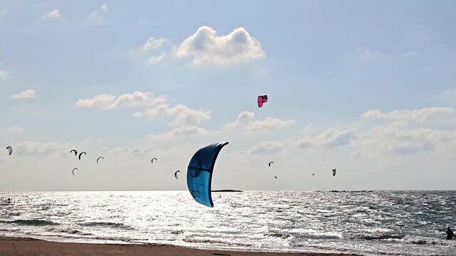 Large number of professional athletes train in windsurfing on a Mediterranean Sea near Rosh HaNikra in northern Israel