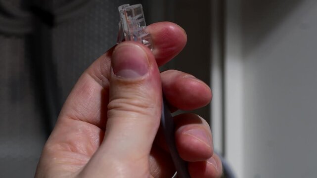 Gray internet cable for connecting to a router.
Cable connection, data transmission.
