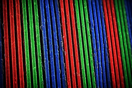 Glowing red green blue OLED subpixel matrix in macro closeup