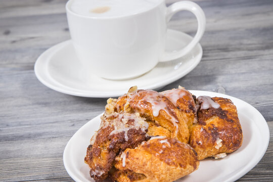 Croissants from polish city Poznan baked according to traditional recipe with poppy seed filing and cup of coffee