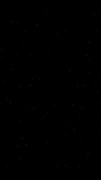 Glowing gold dust particles floating slowly upward against a deep dark black background