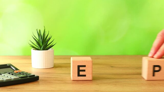 Businessman moves the blocks EPR symbol and reveals Extended Producer Responsibility. A business-environmental concept. Coverage by companies operating in the EU of recycling and environmental fees