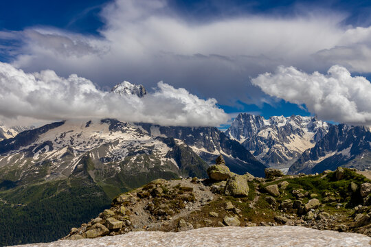 Impressive view of Les Drus, a dramatic pair of granite peaks in the Mont Blanc massif of the French Alps near Chamonix. The iconic mountain formation rises above deep alpine valleys