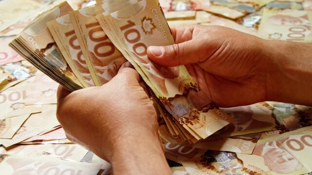 A pair of hands counts a thick stack of Swiss 100-franc banknotes above a table scattered with cash, with more bills spread across the surface