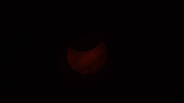 Glowing crescent phases of the 2026 solar eclipse above Nova Scotia, Canada, as the moon crosses the sun