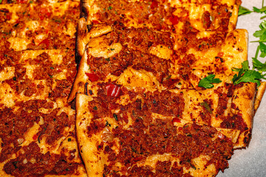 &bull; Slices of traditional Turkish flatbread pide with minced meat and spinach on a hotel buffet display.