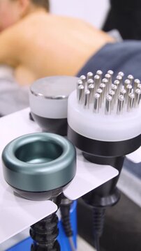 Professional body shaping therapy with vibromassage thermo vacuum and bioelectrical stimulation in beauty salon - vertical video