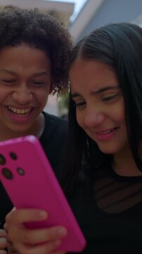 Teenagers reacting to phone post with mixed emotions for social media dynamics