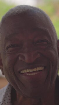 Happy African American senior man smiling and laughing outdoors, conveying joy