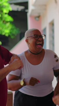 Multigenerational diverse group dancing outdoors celebrating friendship and togetherness