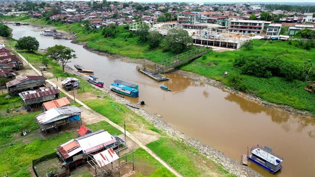 Panoramic aerial view of the traditional riverside district of Belen in Iquitos, showing characteristic stilt houses (palafitos) along the banks of the Itaya River in the Peruvian Amazon.