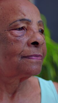 Thoughtful elderly African American woman profile portrait outdoors, close up