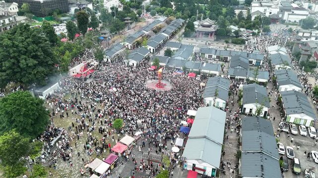 Aerial view of the Torch Festival celebration with crowds around the central torch pole, Southwest China, D-Log lossless file format