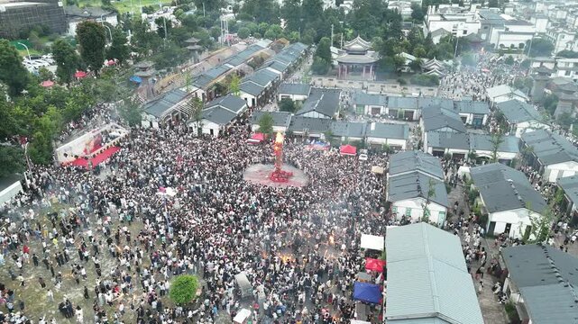 Aerial top view of a dense crowd and red festival decorations at the Torch Festival, Southwest China, D-Log lossless file format