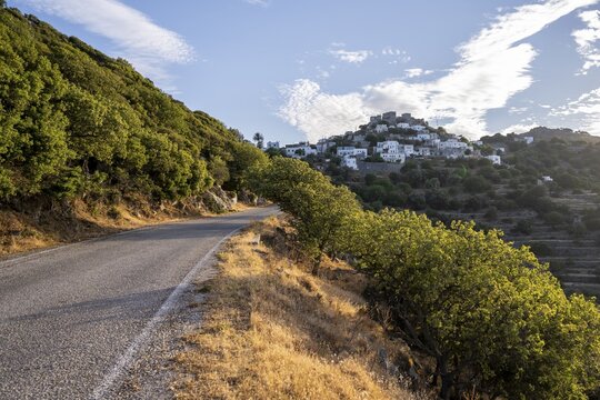 Road in the evening light, mountain village of Emporios in the back, Nisyros, Dodecanese, Greece