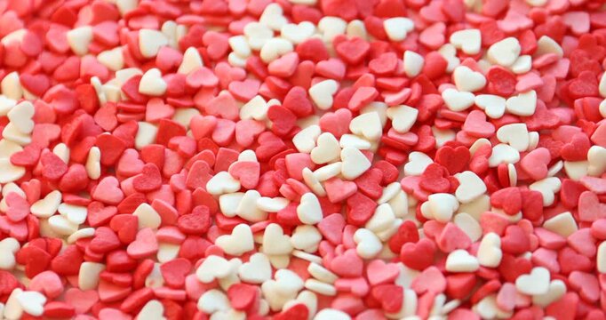 Confetti sprinkles in shape of heart. Decoration for dessert