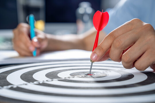 The process of hitting the bullseye, symbolizing the achievement of a business goal.